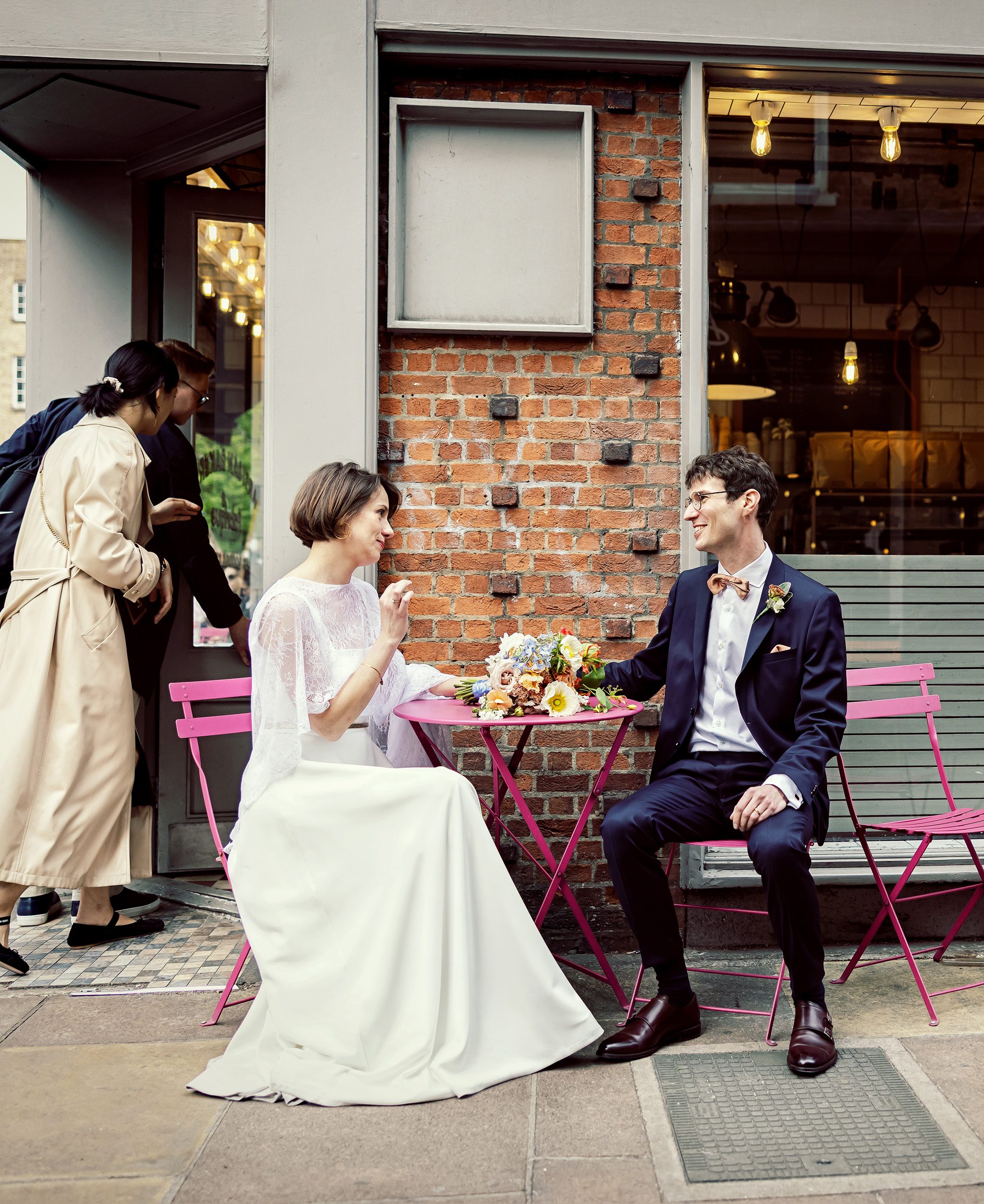 Bride and groom sit outside Fitzrovia Bakery image