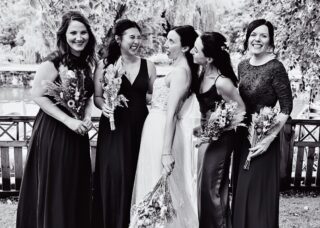 Bridesmaids messing around by River Thames wedding