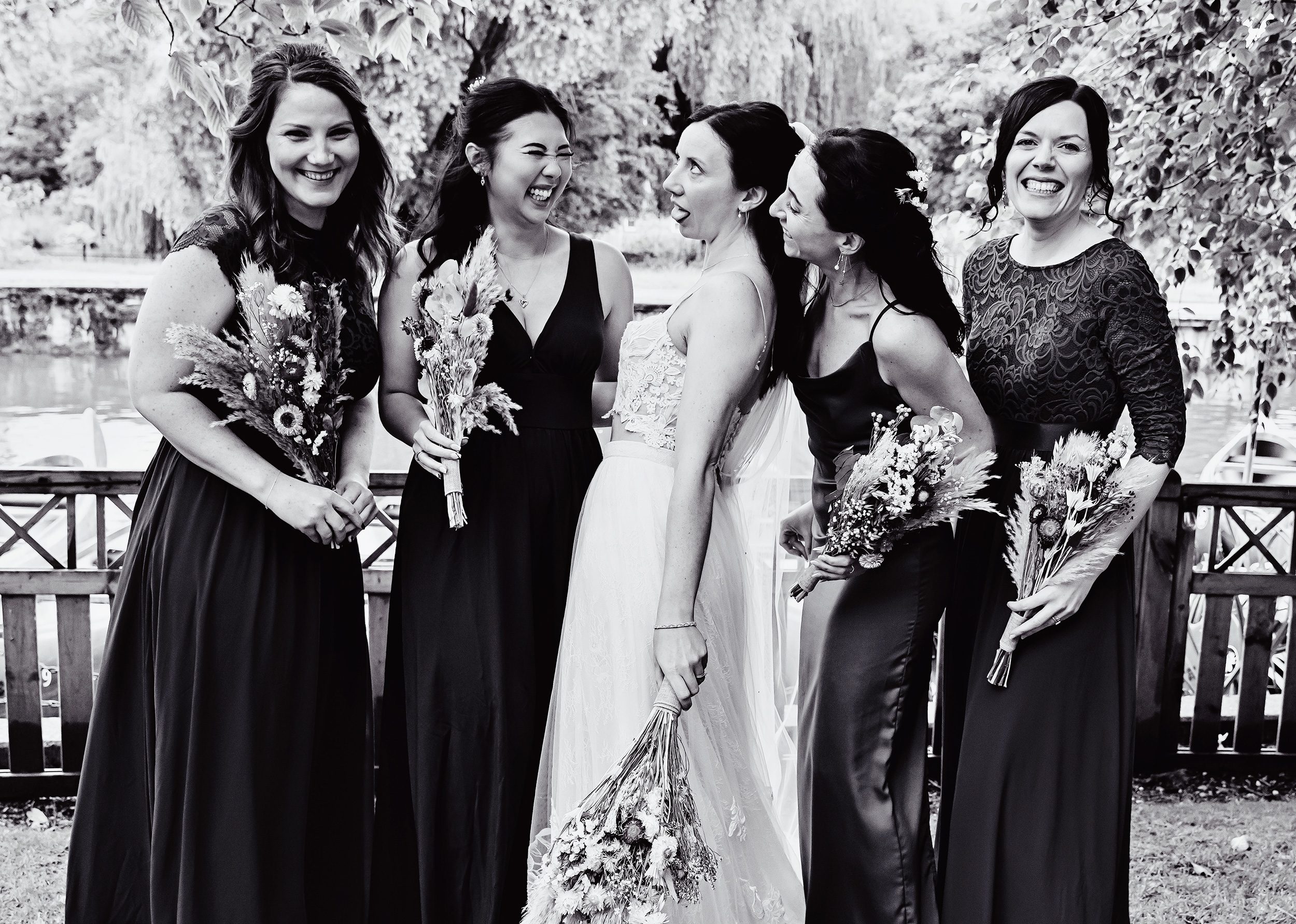 Bridesmaids messing around by River Thames wedding