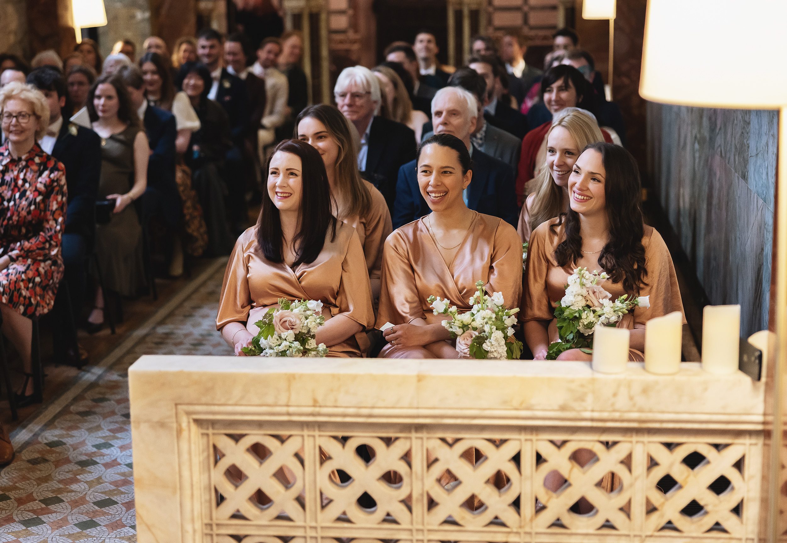 Bridesmaids smiling during Fitzrovia Chapel wedding ceremony