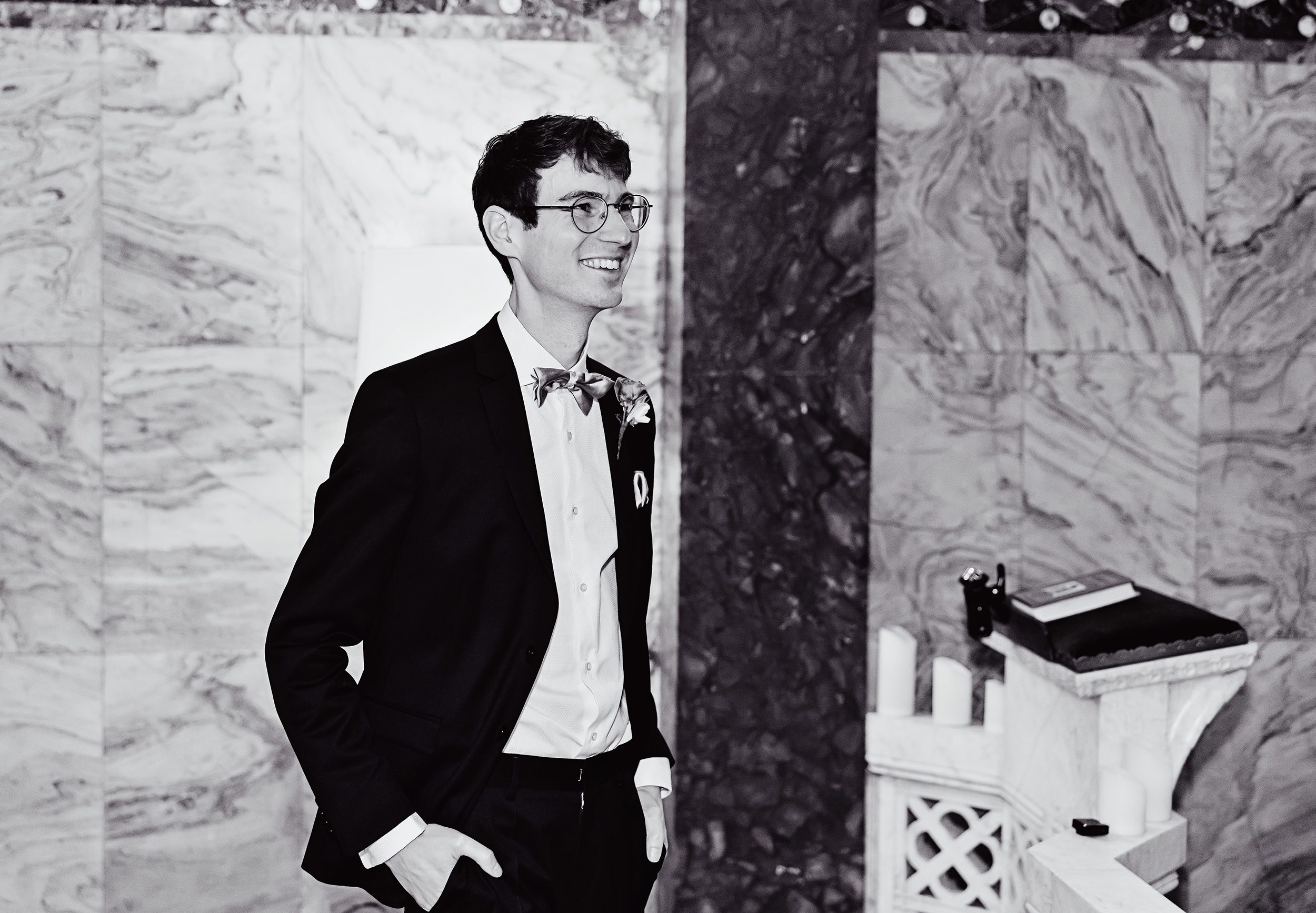 Groom laughing pre ceremony inside Fitzrovia Chapel London