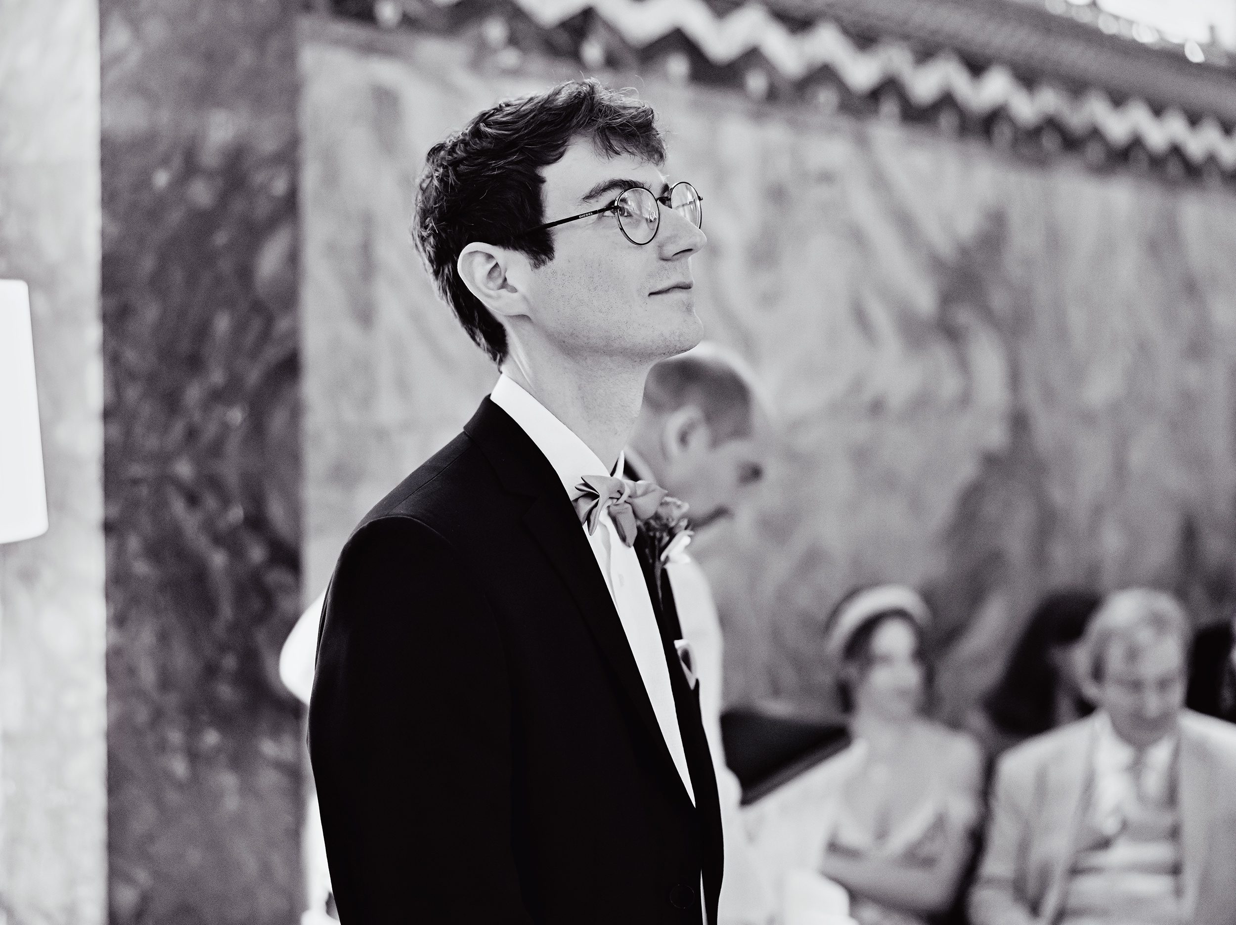 Groom waits eyes open Fitzrovia Chapel wedding ceremony