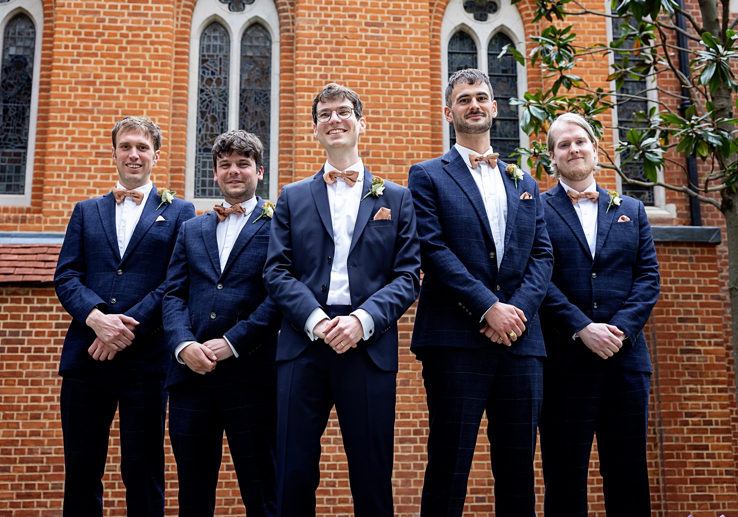 Groomsmen together outside Fitzrovia Chapel