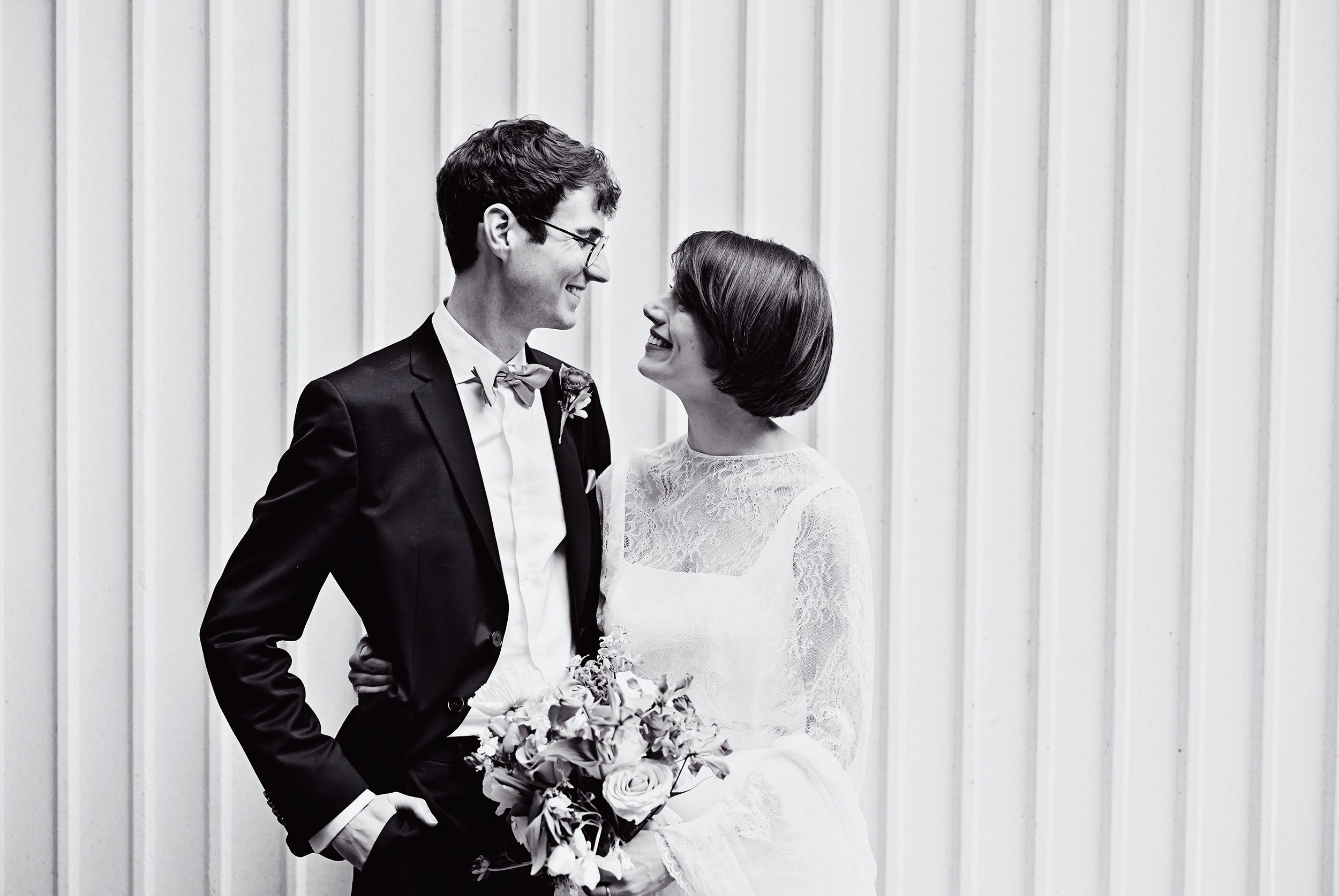 Wedding couple in front of corrugated wall in Fitzrovia