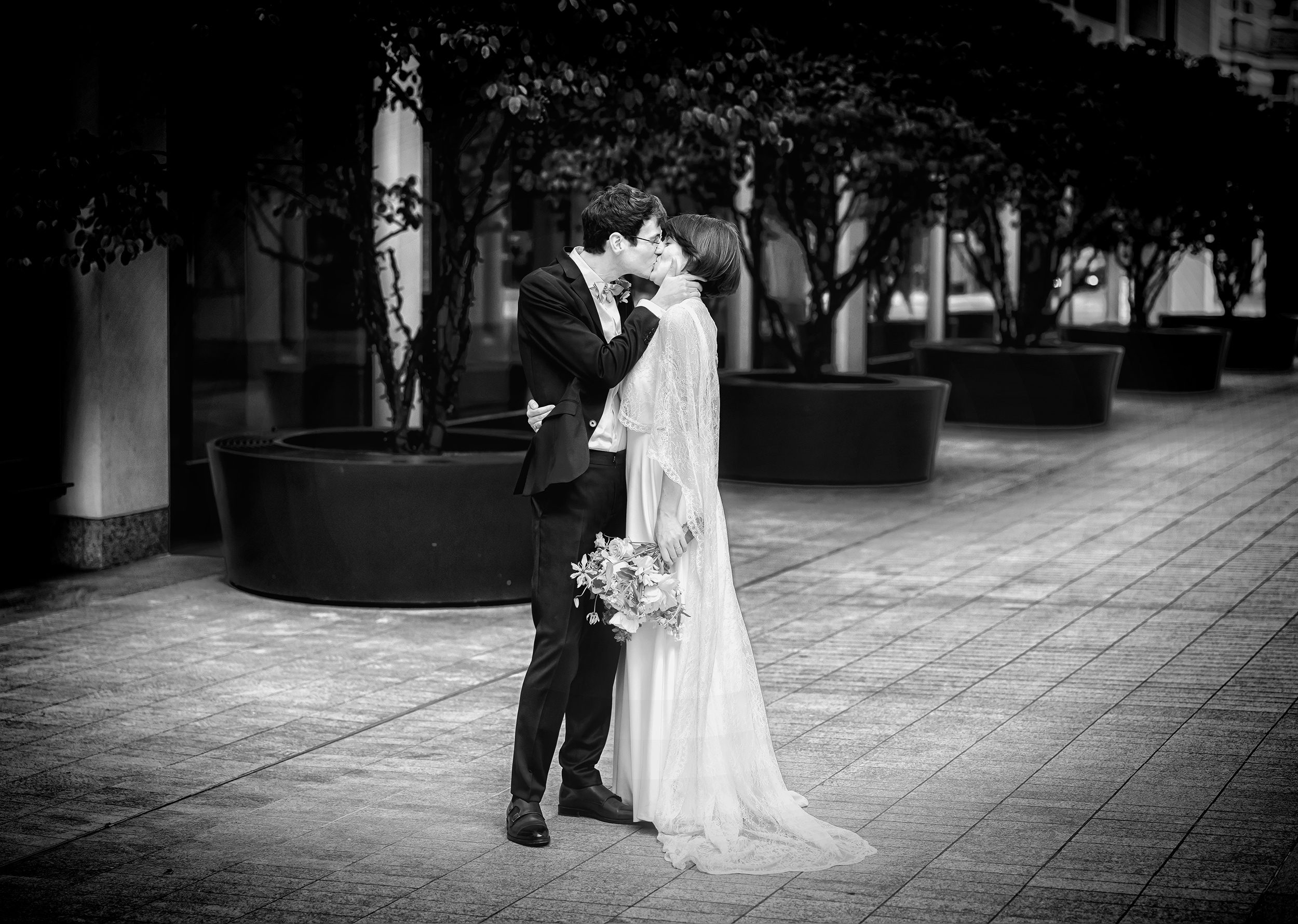 Wedding couple kiss in the middle of Fitzrovia central London