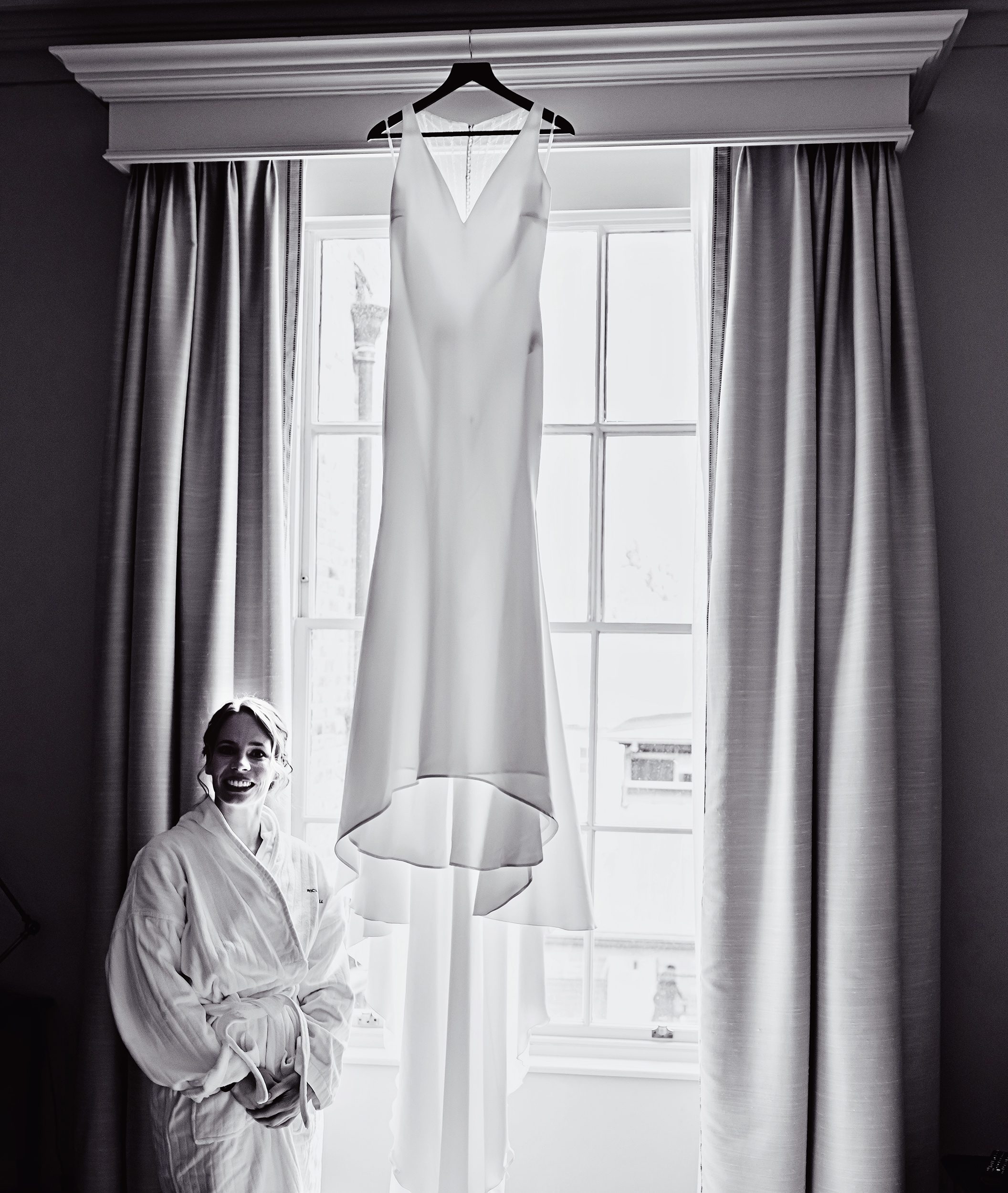 Bride by hanging wedding dress Richmond Hotel