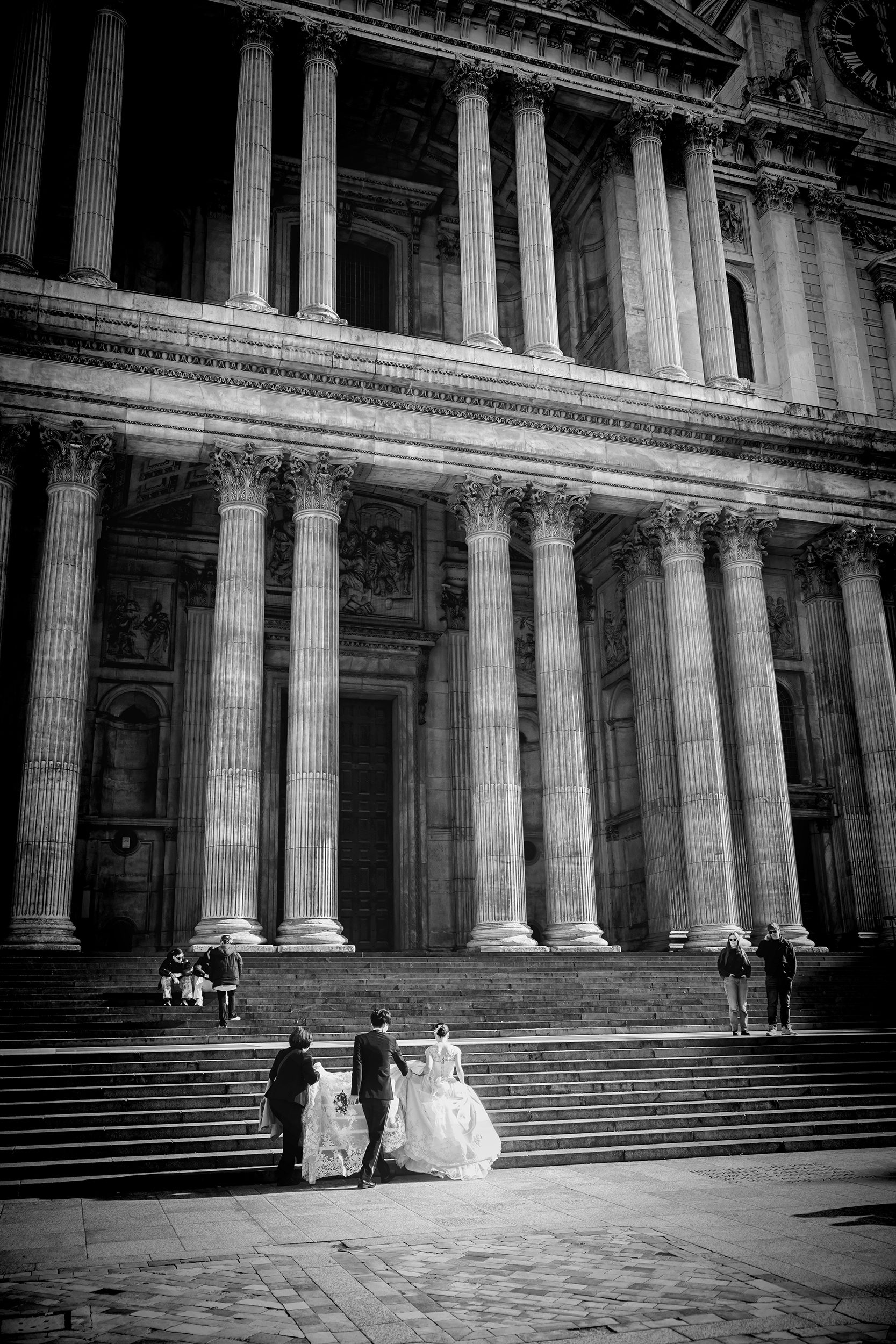 Bridal party going up steps to St Pauls Cathedral