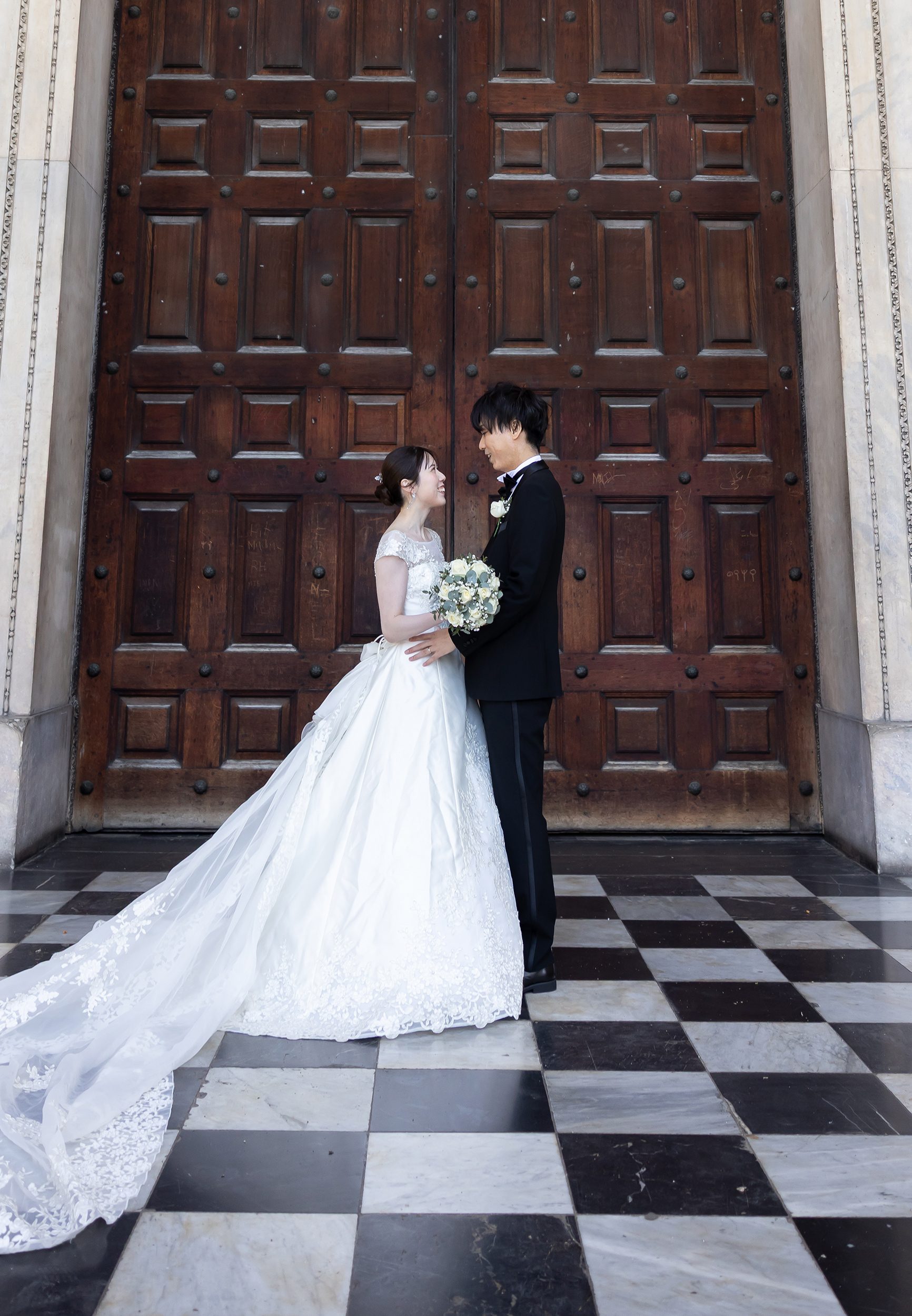 Bride and groom face each other St Pauls Cathedral