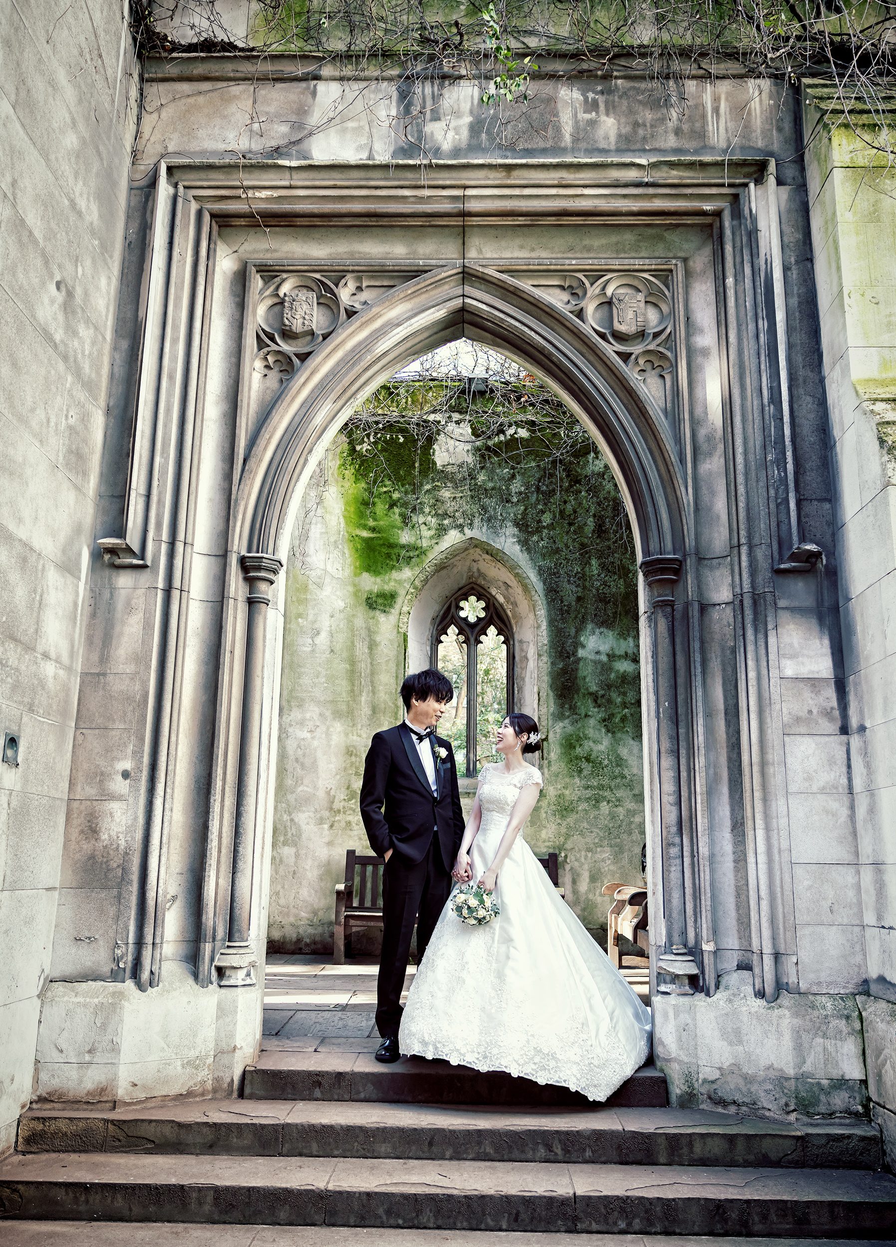 Bride and groom in arch St Dunstan in the East