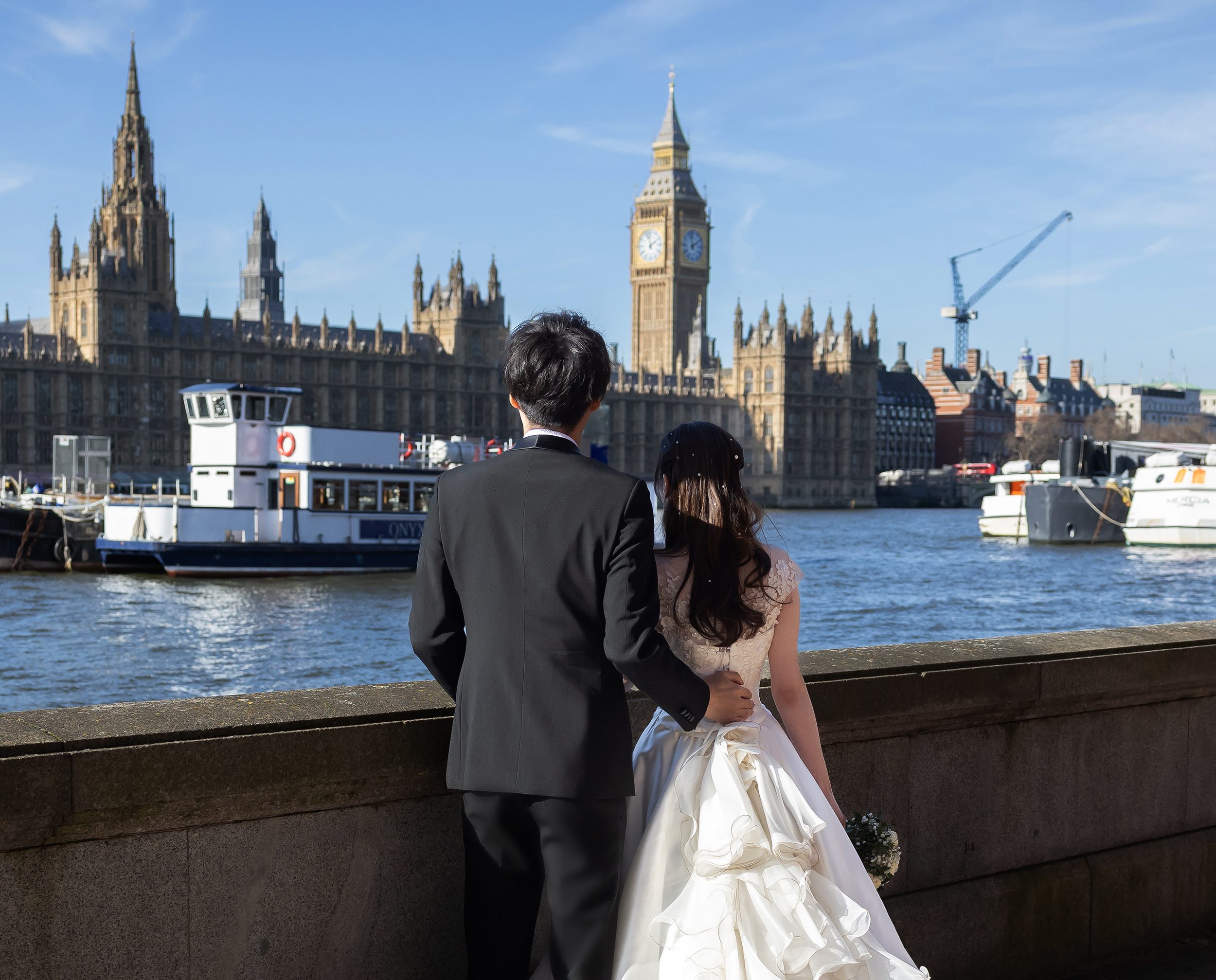 Bride and groom watching Parliament and Big Ben