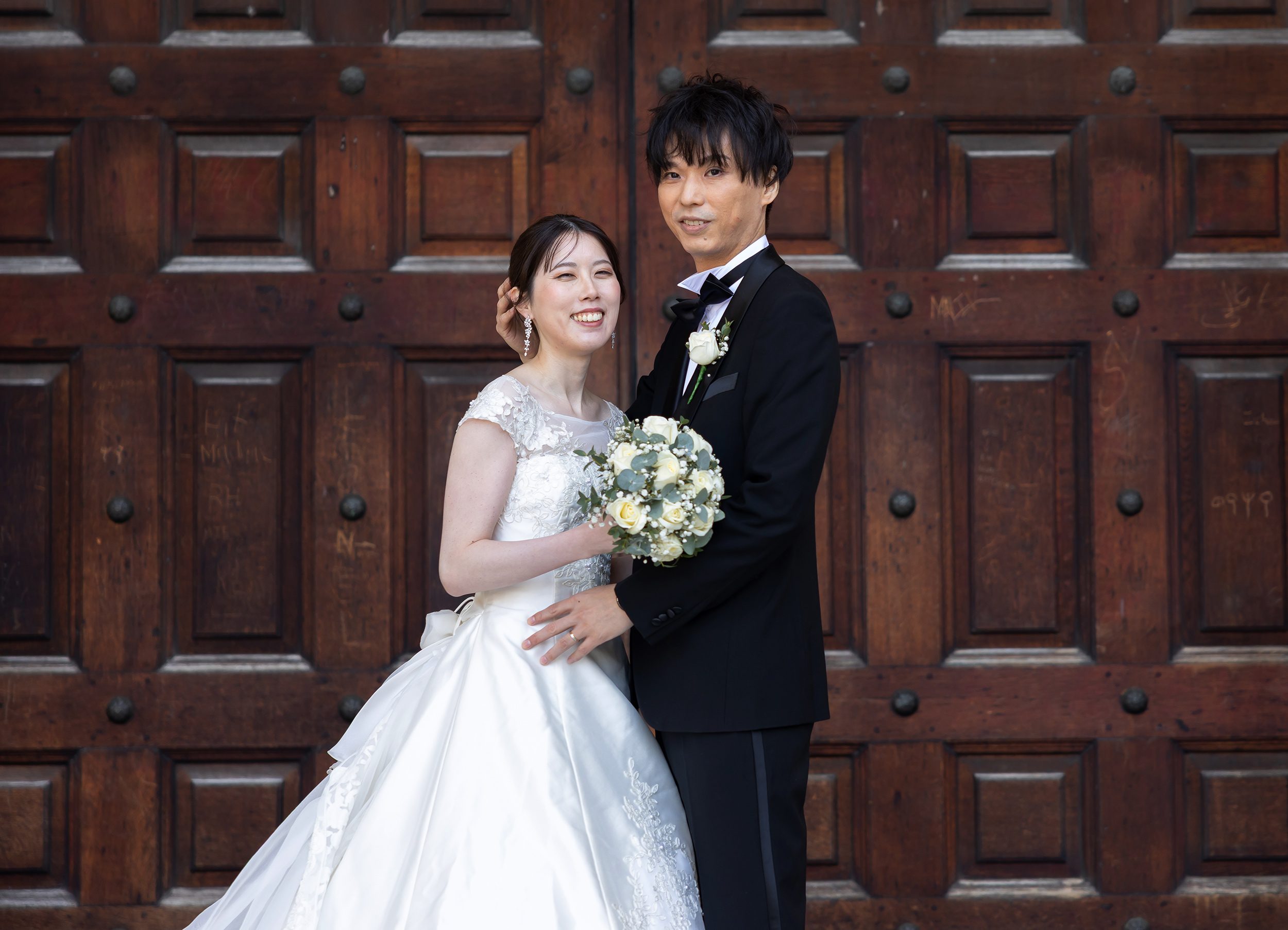 Japanese wedding couple face camera St Pauls Cathedral