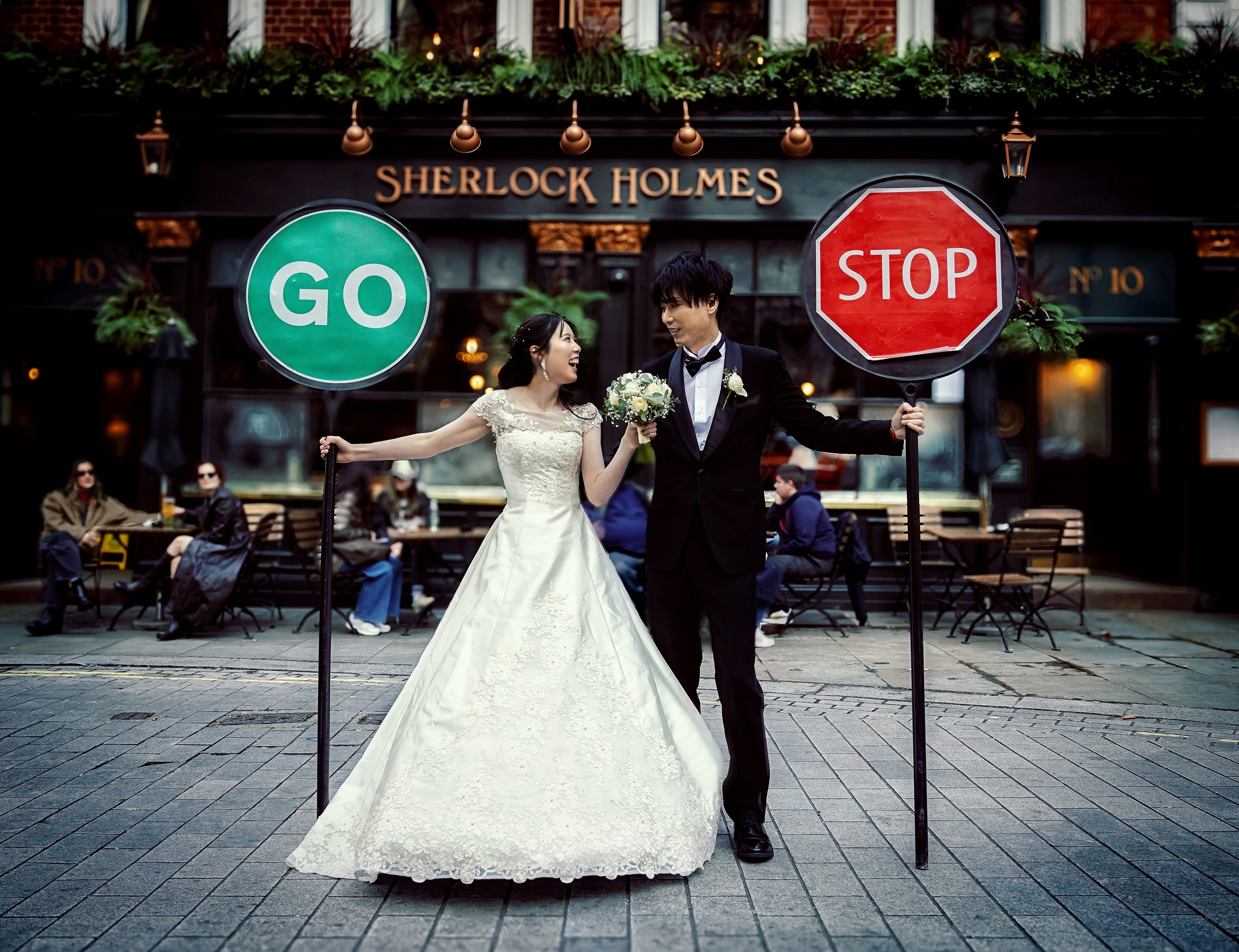 London Wedding couple pose with stop go signs Charing Cross