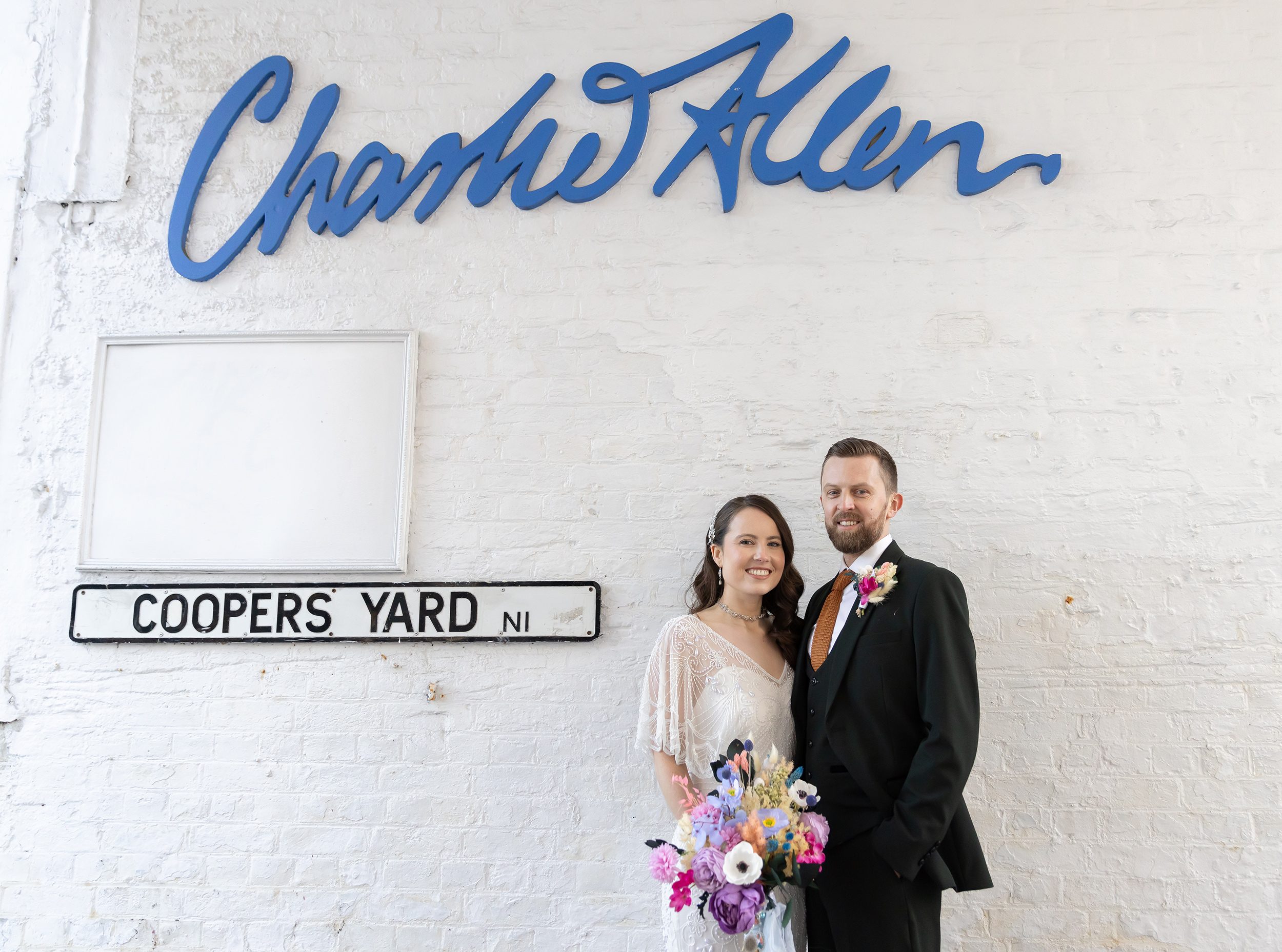 Islington wedding couple pose by street sign Upper Street