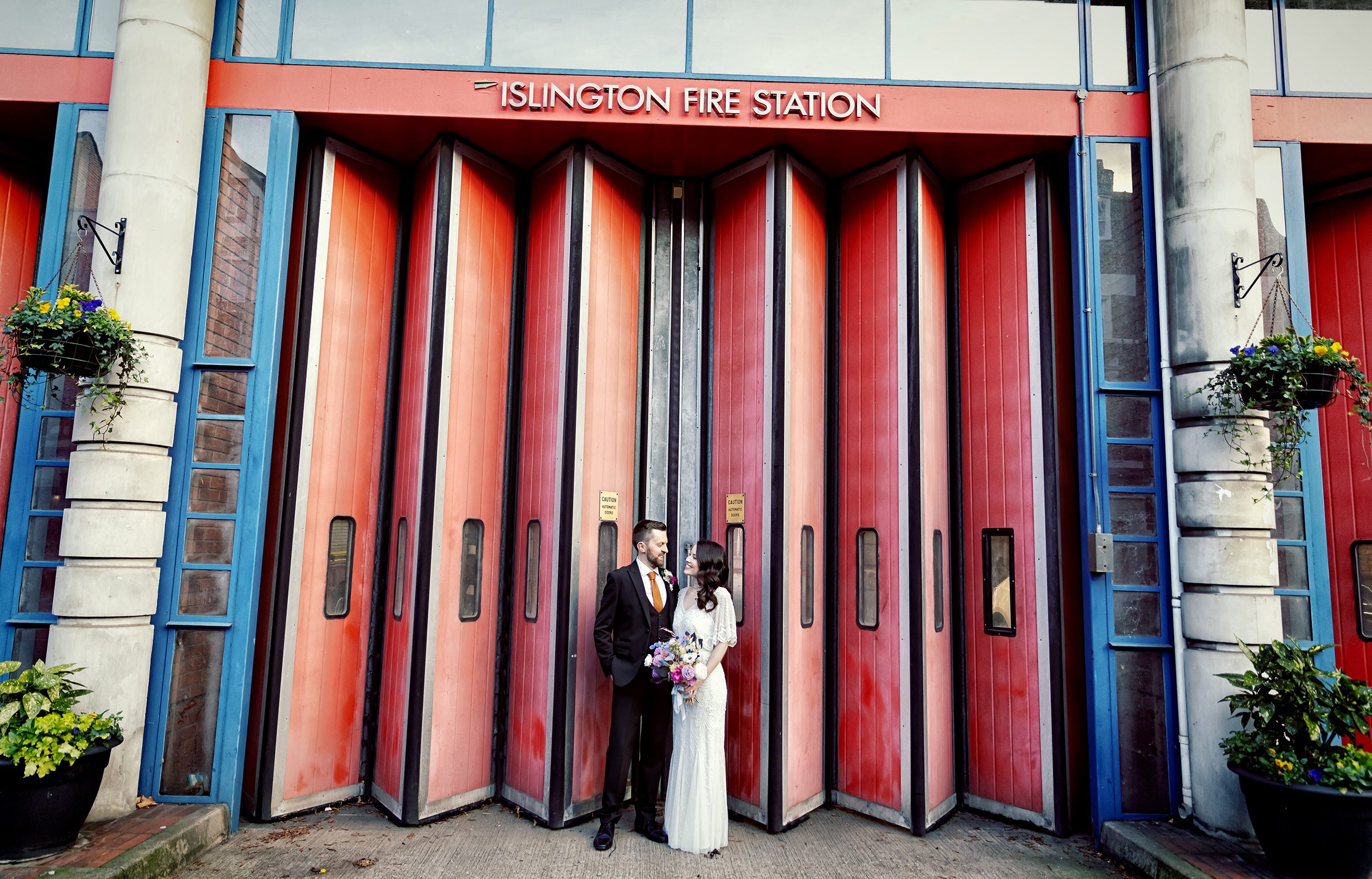 Wedding couple in front of Islington Fire Station